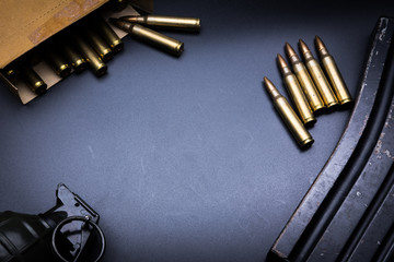 Rifle cartridges 5.56 mm and magazine on a black background
