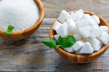 White figured sugar in a wooden bowl.