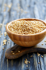 Seeds of oats in a wooden bowl.