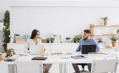 Businessman and Businesswoman Working Together at Office