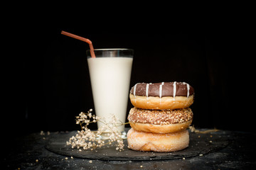 Tasty doughnuts with sprinkles with milk