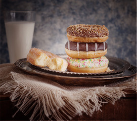 Tasty doughnuts with sprinkles with milk