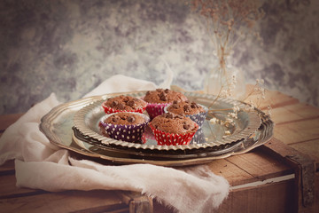 mini chocolate cupcakes on silver plate in rustic style