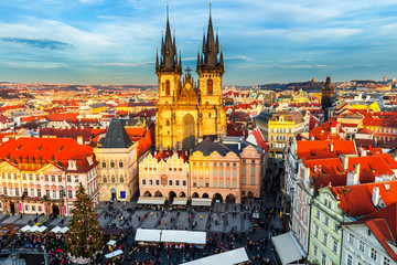 Old Town of Prague, Czech Republic. View on Tyn Church and Jan Hus Memorial on the square as seen from Old Town City Hall. Blue sunny sky