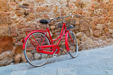 Beautiful narrow alley with traditional historic houses at Pienza city