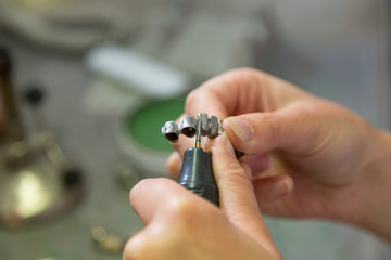Fototapeta premium Technician polishing or grinding dental implant