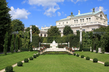 Fototapeta na wymiar View of the Volksgarten People`s Garden with historic Burgtheater in the background, Vienna, Austria