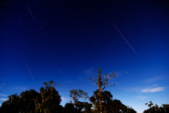 Perseid Shower Meteor On Full Moon Sky.