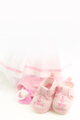 cute Baby pink clothes for newborn  on abstract light background.  concept of child birthday, newborn party baby girl style. element for your design. copy space