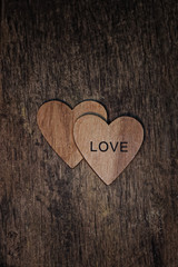 Obraz premium Two wooden hearts with text 