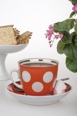 Red cup of coffee French crackers