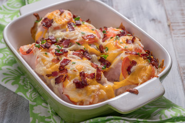 Chicken breast baked with cheese, bacon and tomatoes