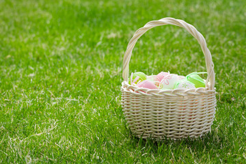 Fototapeta na wymiar Easter eggs basket on grass
