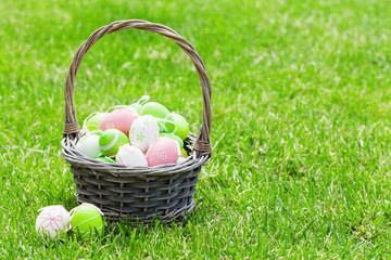 Easter eggs basket on grass
