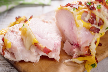 Chicken breast baked with cheese, bacon and tomatoes