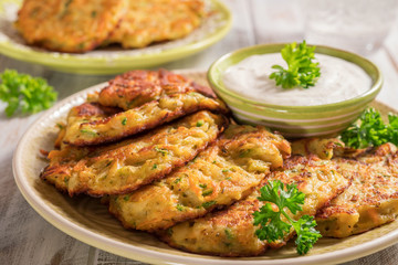 Obraz premium Vegetable fritters with potato, carrot, zucchini served with Ranch sauce.
