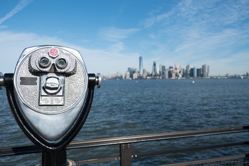 Manhattan skyline and New York Harbor seen from a distance on Liberty Island.  Tower viewer...