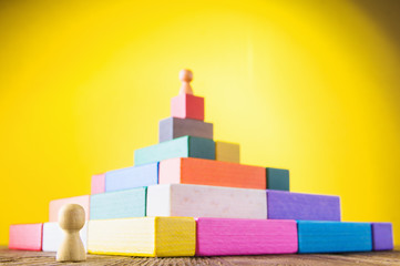 Business metaphor. Concept of business learning success. Man climbs the stairs of the pyramid. ...