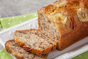 Sliced banana bread with a pecan