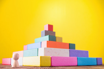 Business metaphor. Concept of business learning success. Man climbs the stairs of the pyramid. ...