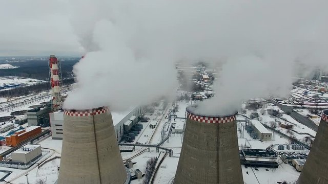 Air pollution. Power plant with smoke from chimneys. Drone shot. 4K.