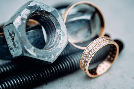 macro of wedding rings with diamods on grey concrete in day light