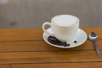Hot coffee in a white cup on the table.