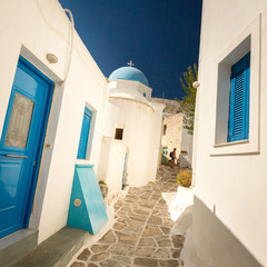 Traditional blue shutters on white buildings Paros