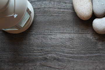Background with angel and stones on a dark wooden table