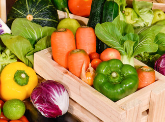 Arrangement fresh fruits and vegetables in wooden container