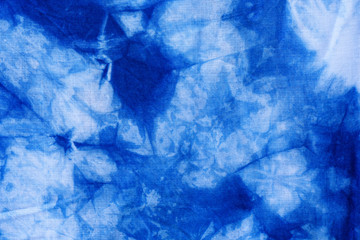 Pattern of blue tie batik dye on cotton cloth, Dyed indigo fabric background and textured, Painted blue watercolor on white cotton cloth