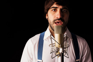 Singer with microphone and black background