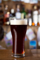 alcohol cocktail on wooden bar with bar background