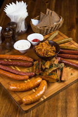 assortment hot sausages serving on wooden board