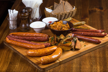 assortment hot sausages serving on wooden board