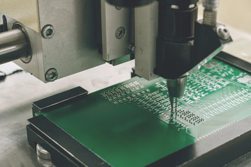 Automation of machine assembly of computer circuit board in the factory for the production of computer components. The process of soldering the board. Factory for the production of microchips.