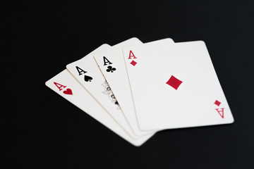 Playing poker cards aces on black background
