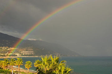 Rainbow appeared after heavy rain. Beautiful landscape photo. Marina di Patti. Sicily