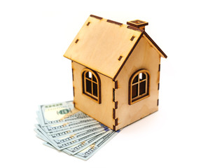 hundred-dollar bills and wooden toy house
