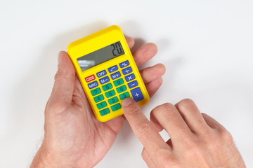 Hands calculate using a calculator on a white background