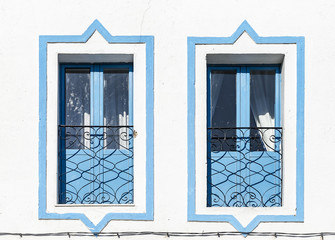 blue windows on a white wall