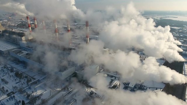 Air pollution concept. Power plant with smoke from chimneys. Drone shot. 4K.