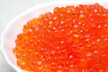 Red caviar of a salmon in a saucer.