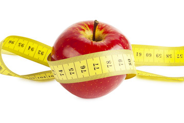 red apple with measure tape on white background