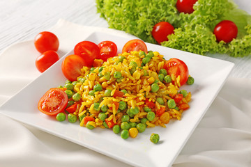 Delicious rice with vegetables on white plate