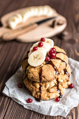Peanut cookies with banana and berries on a wooden background