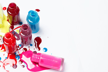 Image of bright-colored nail polish spilling from bottles 