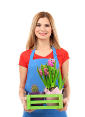 Beautiful female florist holding box with house plants on white background