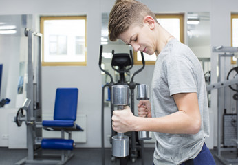 Teenage boy engaged in the gym hall 