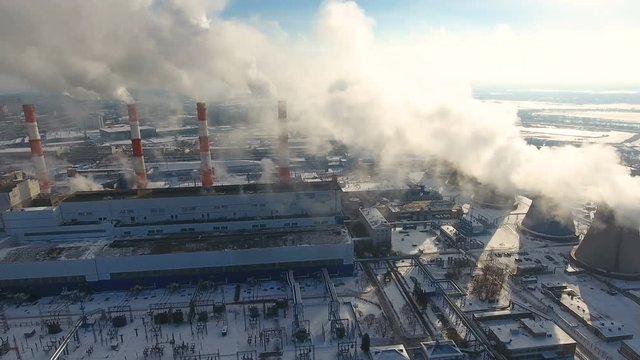 Air pollution concept. Power plant with smoke from chimneys. Drone shot. 4K.